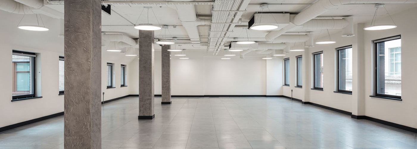 Stripped-back CAT A office floor with exposed services