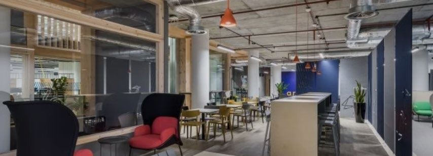Education breakout space with pendant lighting and soft seating